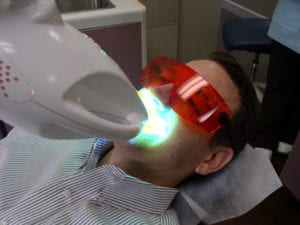 patient under the Zoom whitening light